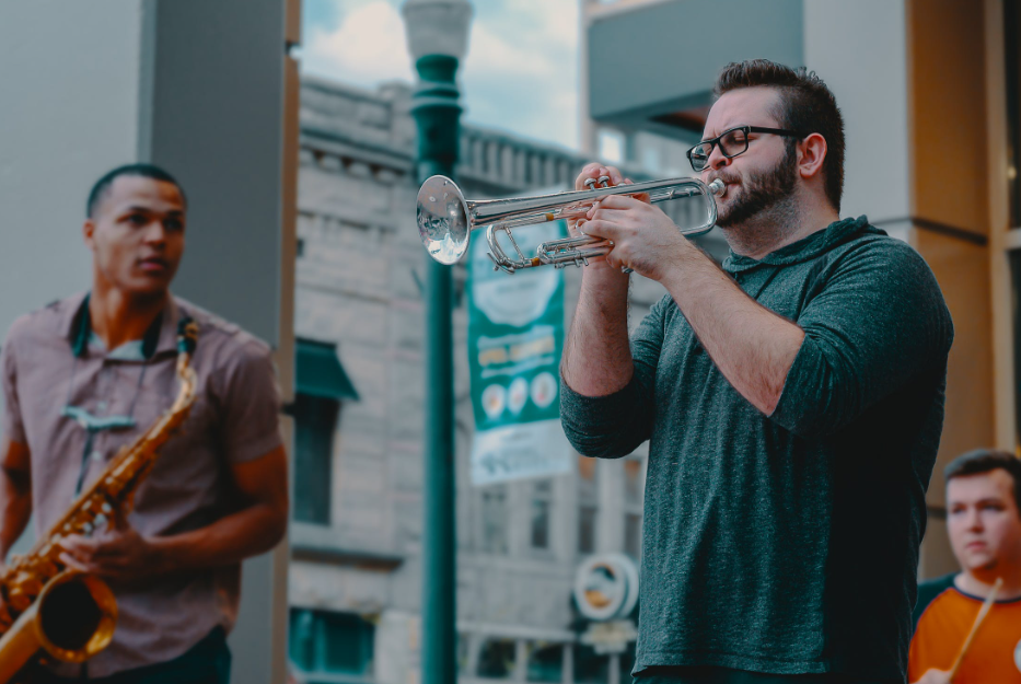 Man playing trumpet with a band.