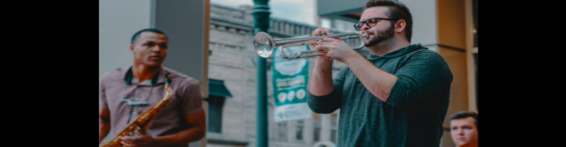Man playing trumpet with a band.