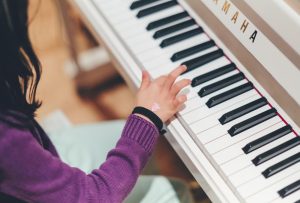 a kid taking piano lessons.