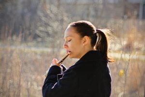  a woman is playing a flute. 