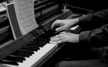 music teacher playing piano