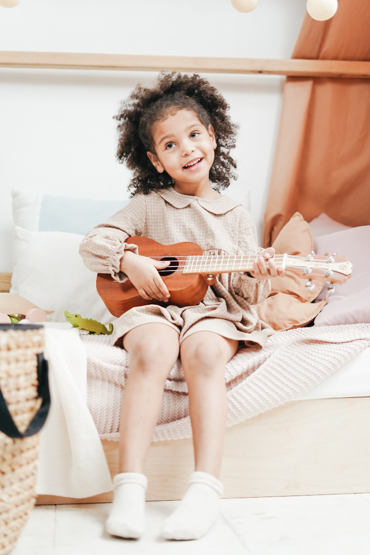A girl playing the ukulele