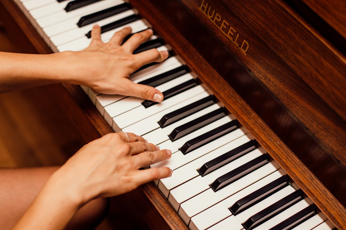 Close-up of hands playing the piano