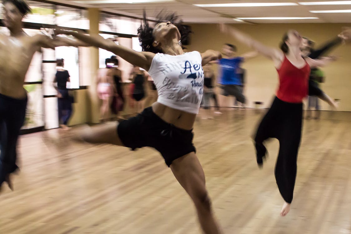 Group of people practicing jazz dance at the studio