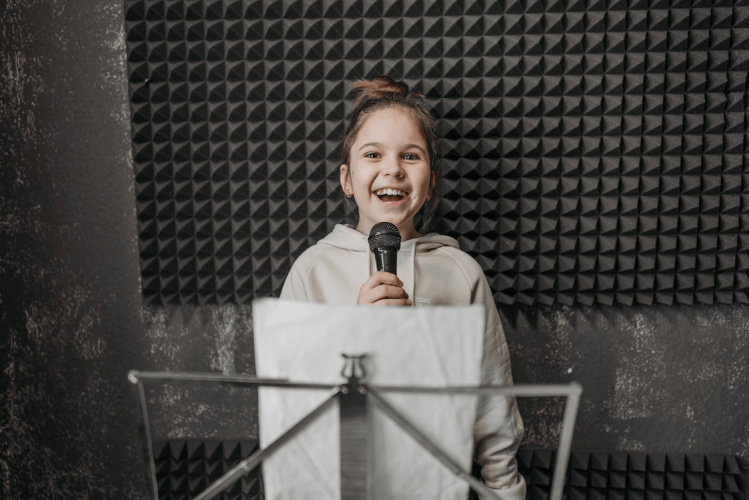 A kid is holding a mic