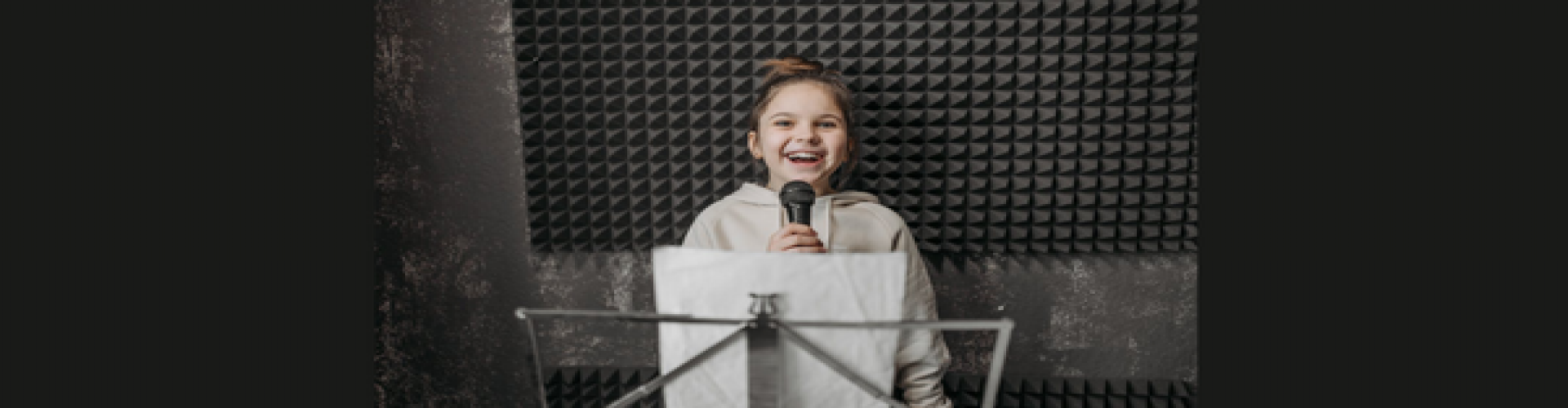 A kid is holding a mic