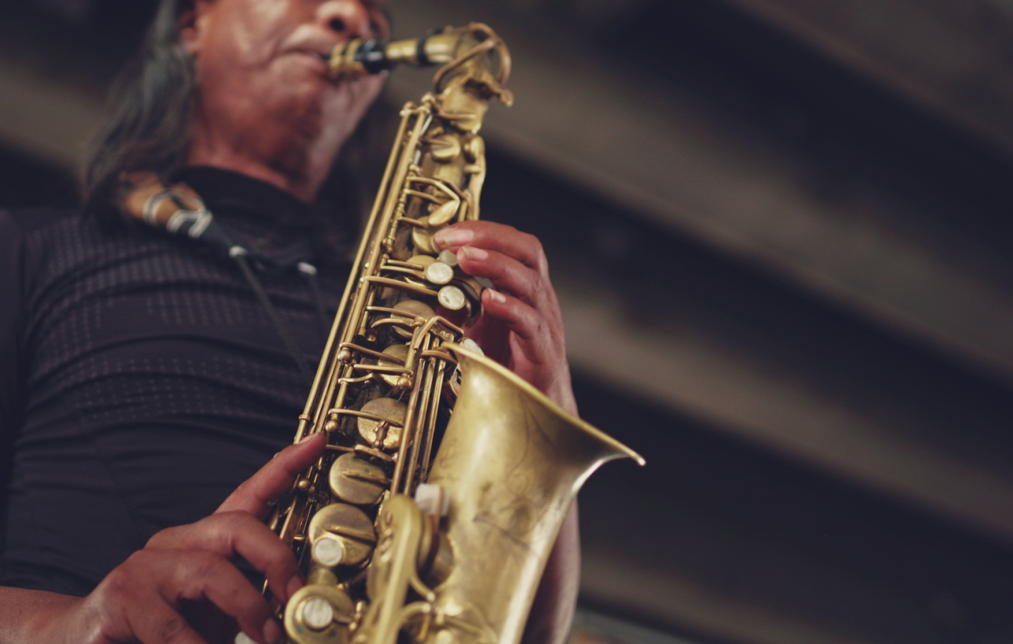 A man playing a golden saxophone